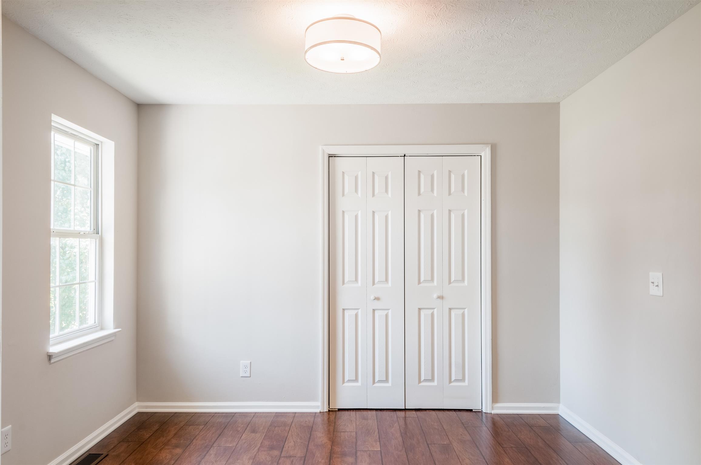 508 Curd Road Mount Juliet, TN 37122 - Photo 4 of 14 an empty room with wooden floor and windows