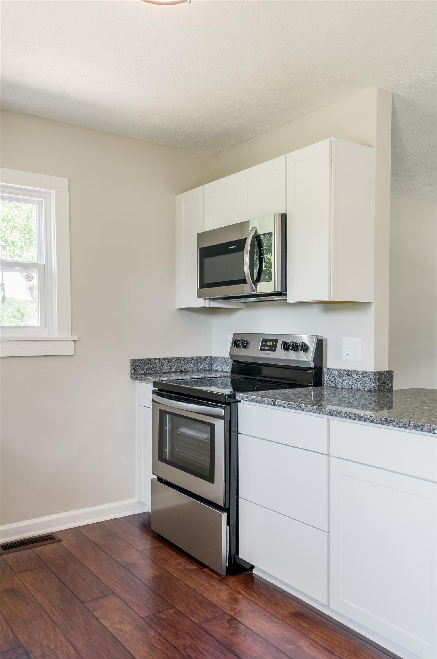508 Curd Road Mount Juliet, TN 37122 - Photo 7 of 14 a kitchen with granite countertop cabinets stainless steel appliances and wooden floor