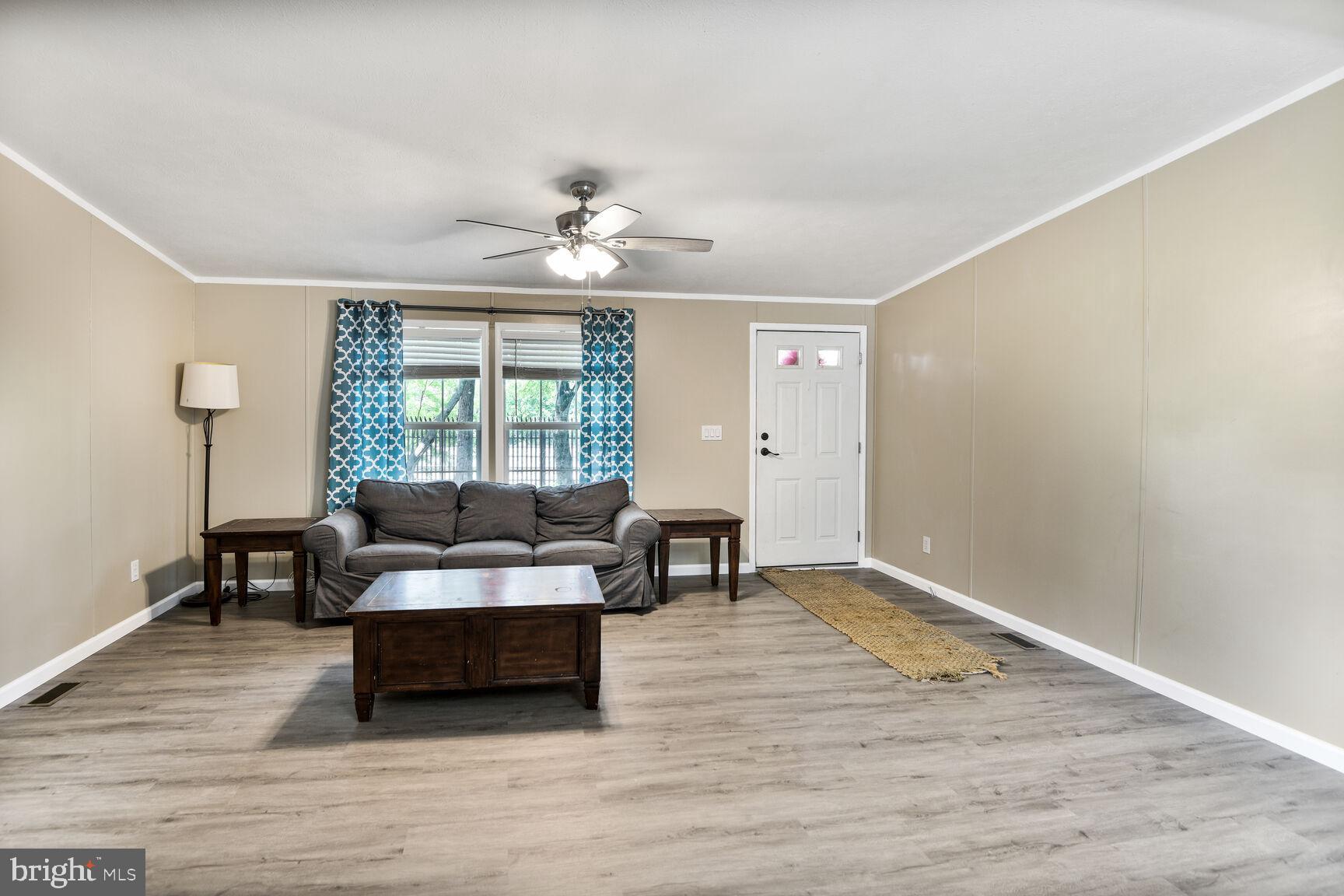 488 North Patuxent Road, Unit 19A Odenton, MD 21113 - Photo 4 of 14 a living room with furniture and a wooden floor