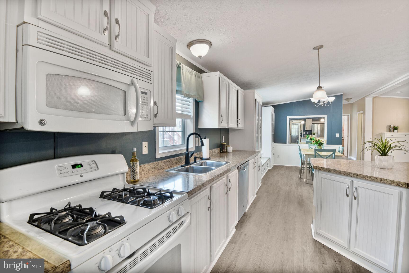 488 North Patuxent Road, Unit 19A Odenton, MD 21113 - Photo 5 of 14 a kitchen with a stove a sink and cabinets