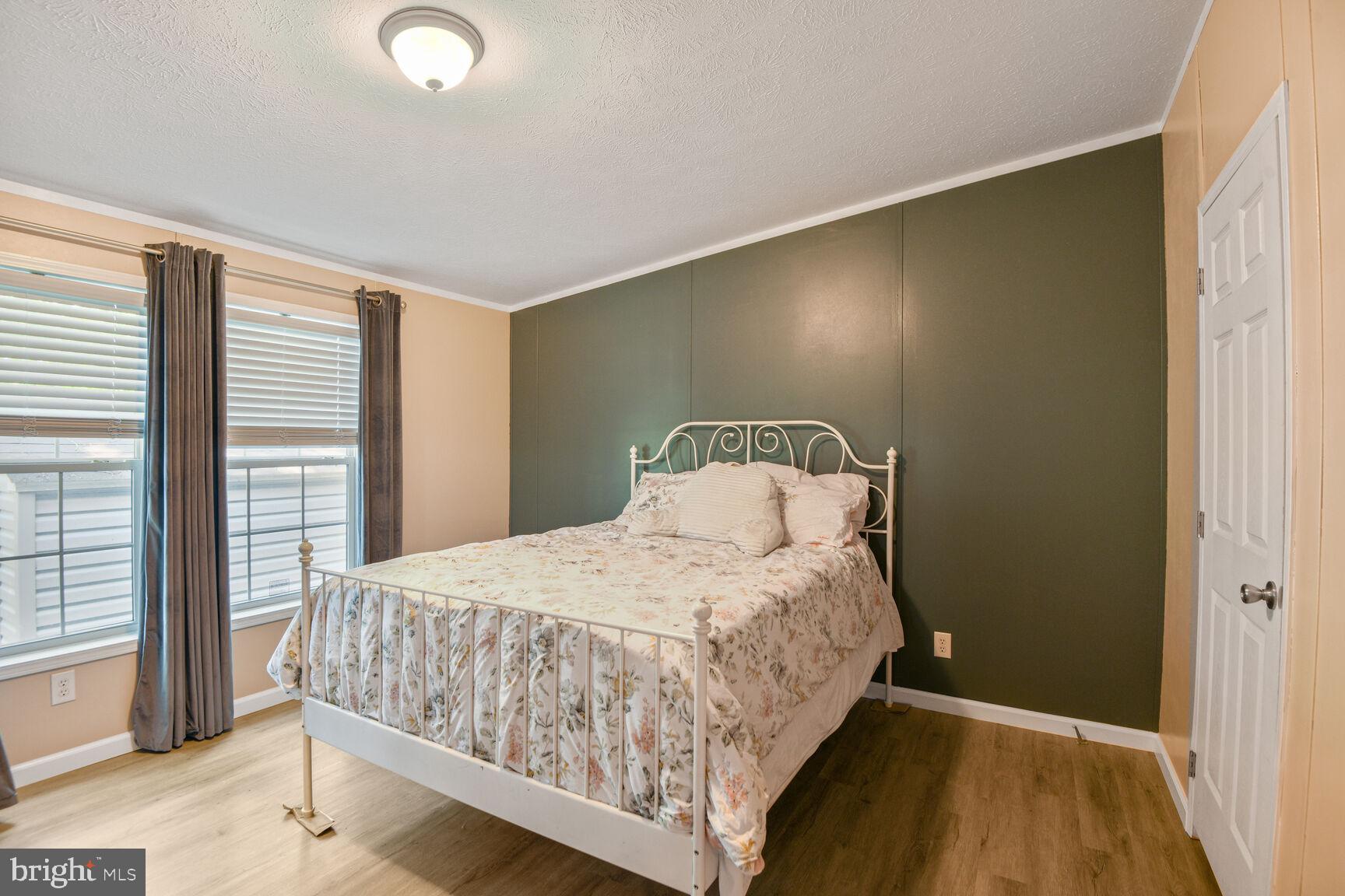 488 North Patuxent Road, Unit 19A Odenton, MD 21113 - Photo 7 of 14 a bedroom with a bed and large windows