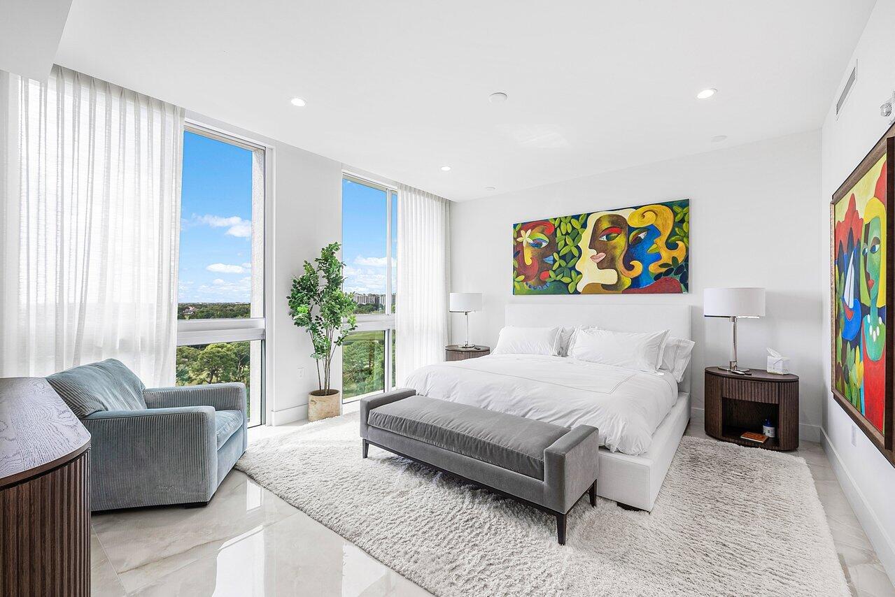 475 East Royal Palm Road, Unit 805 Boca Raton, FL 33432 - Photo 13 of 41 a bedroom with a bed a couch and a large window