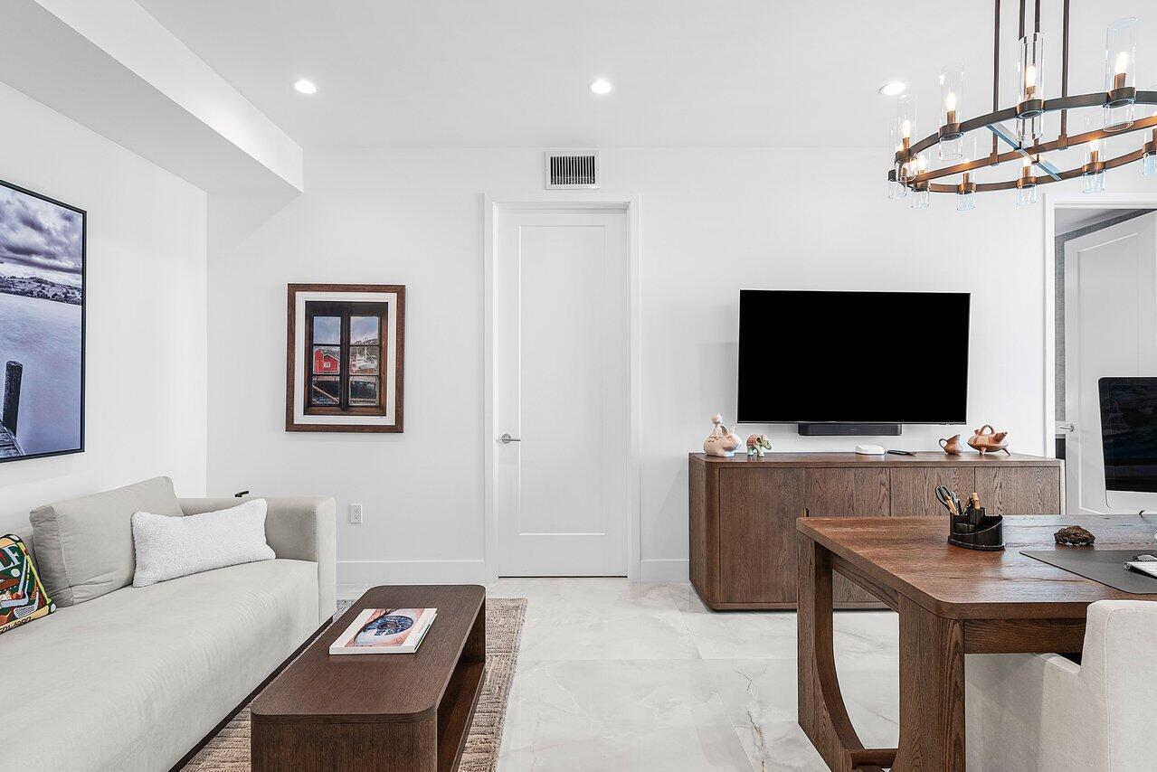 475 East Royal Palm Road, Unit 805 Boca Raton, FL 33432 - Photo 26 of 41 a living room with furniture and a flat screen tv