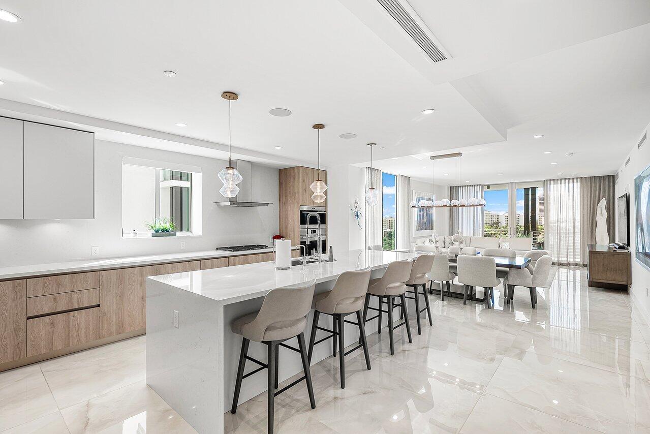 475 East Royal Palm Road, Unit 805 Boca Raton, FL 33432 - Photo 5 of 41 a large kitchen with lots of counter space a sink dining table and chairs