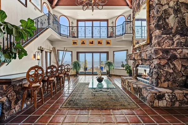 a dining room with furniture a chandelier and wooden floor