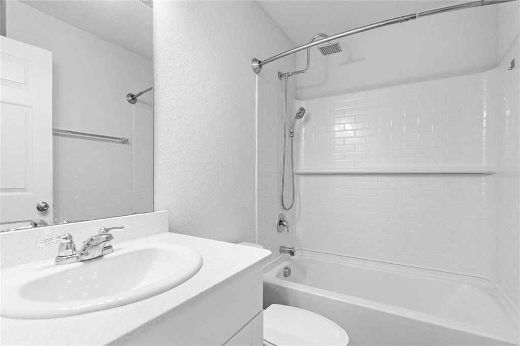 4432 Sagecroft Road Fort Worth, TX 76036 - Photo 12 of 16 Full bathroom featuring a textured wall, vanity, and tub / shower combination