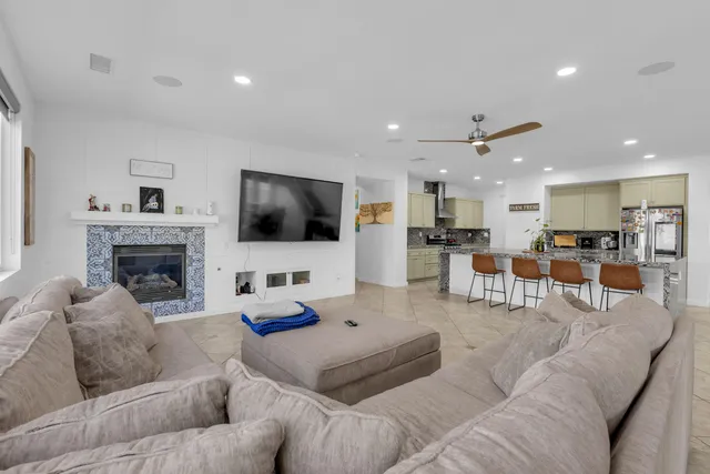 a bed sitting in a spacious bedroom next to a window