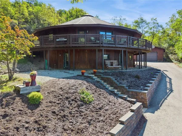 a front view of a house with garden