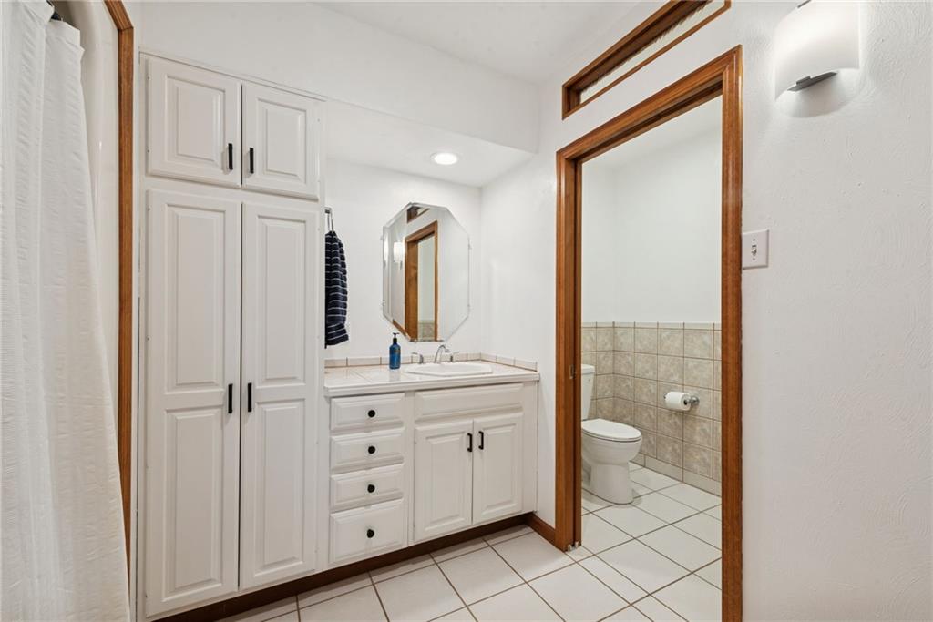 50 Potato Run Road Washington, PA 15301 - Photo 18 of 43 a bathroom with a granite countertop sink two mirror and shower