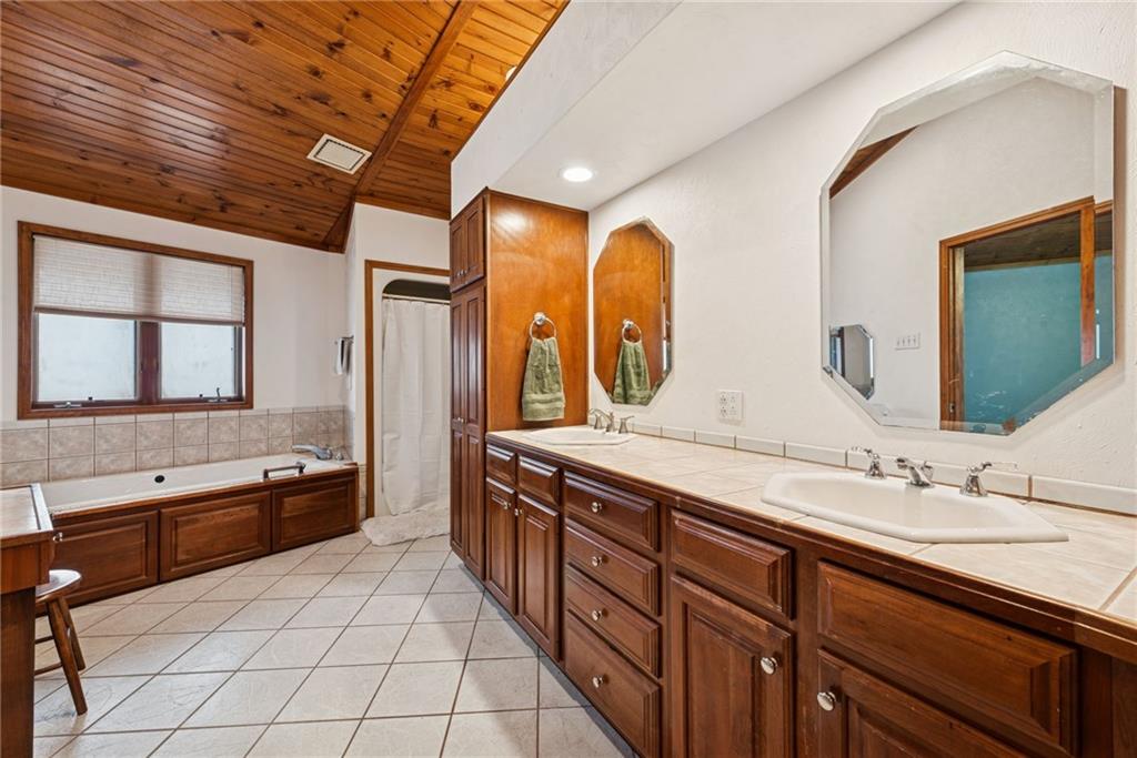 50 Potato Run Road Washington, PA 15301 - Photo 25 of 43 a spacious bathroom with a granite countertop double vanity sink a mirror and a bathtub