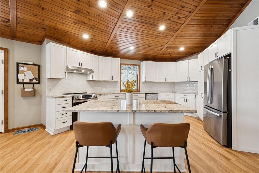 50 Potato Run Road Washington, PA 15301 - Photo 6 of 43 a kitchen with stainless steel appliances granite countertop a stove a refrigerator a sink dishwasher and white cabinets with wooden floor