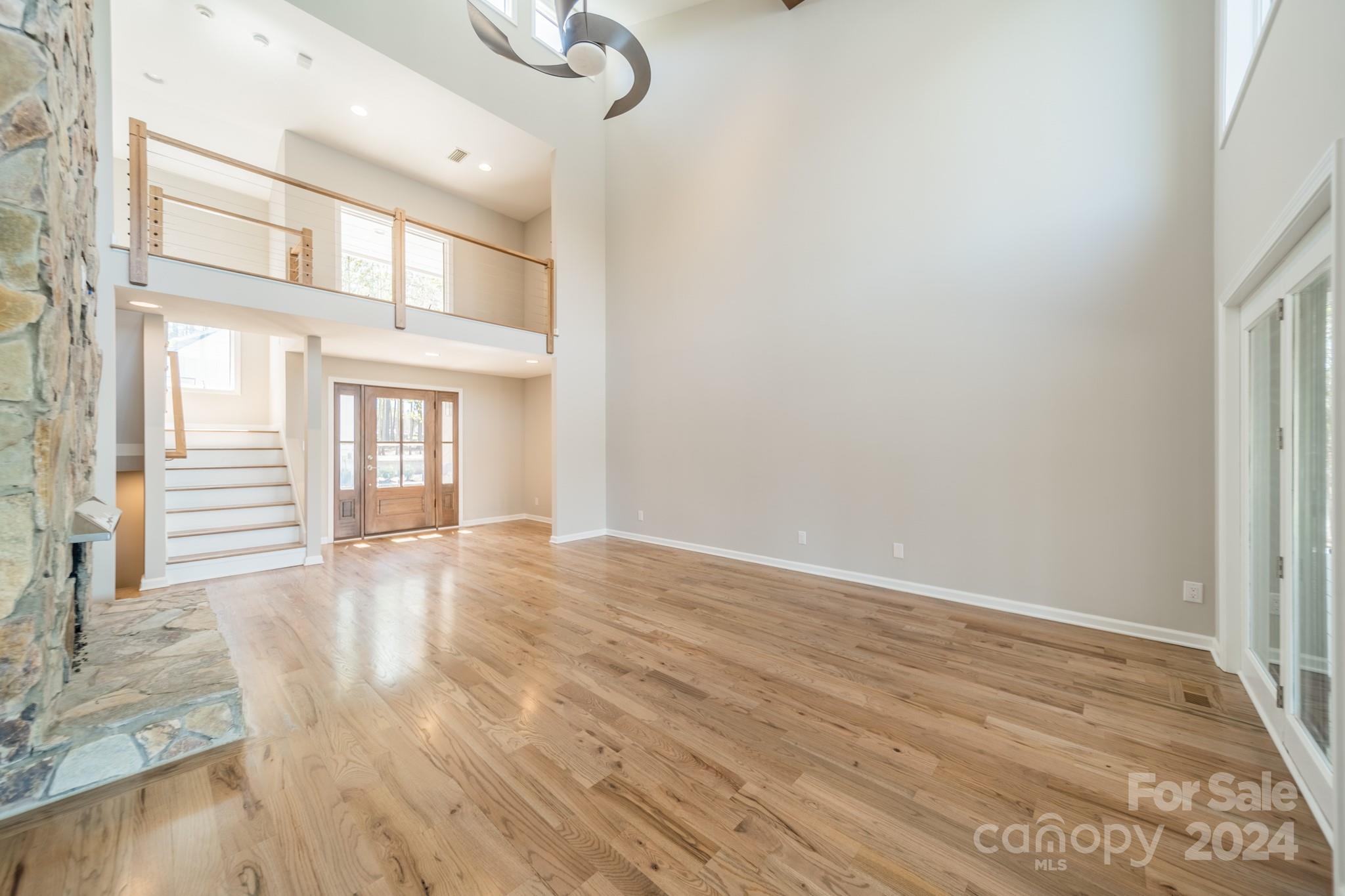 114 Stonemarker Road Mooresville, NC 28117 - Photo 17 of 38 a view of an empty room with wooden floor and a window