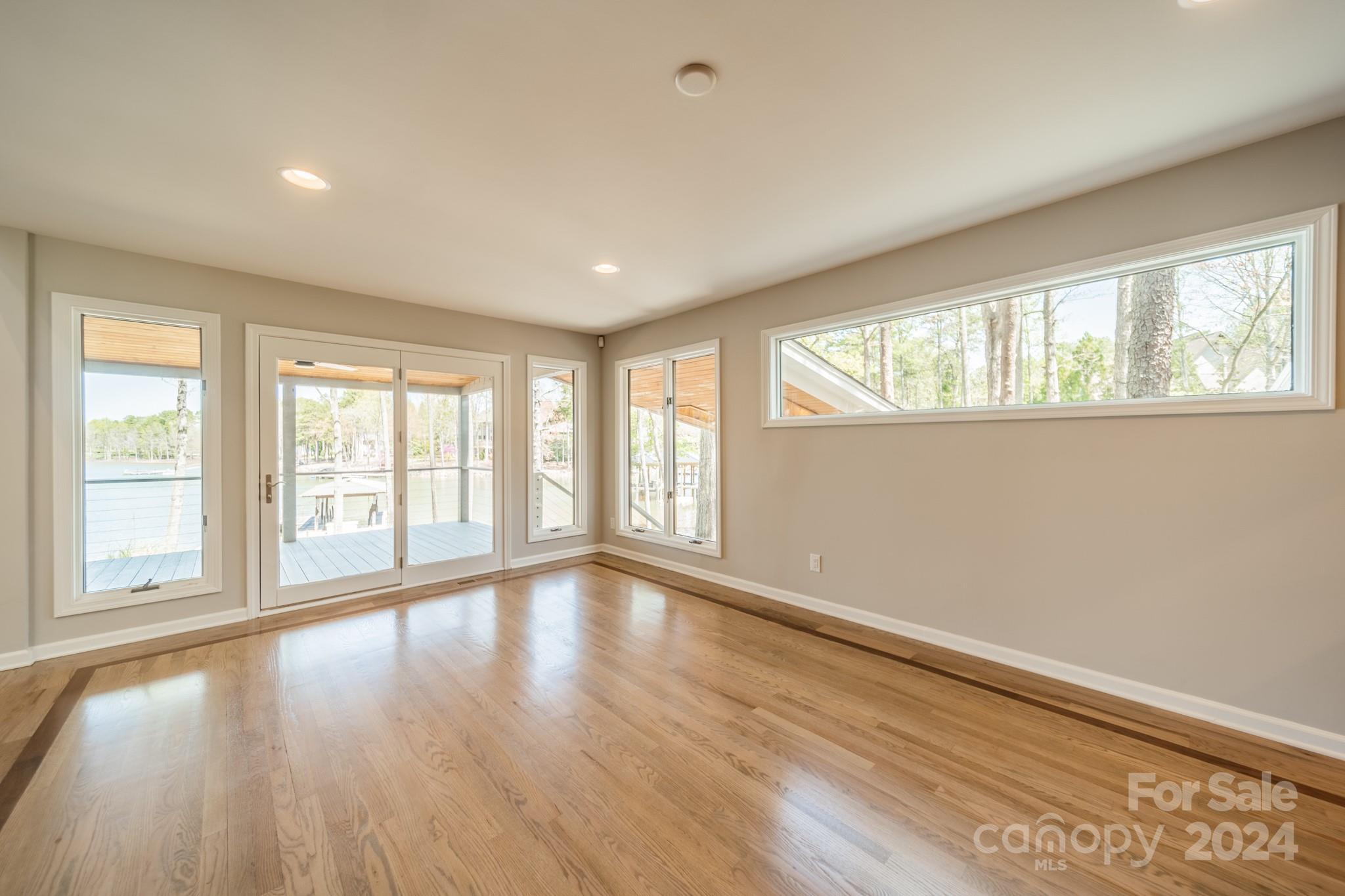 114 Stonemarker Road Mooresville, NC 28117 - Photo 20 of 38 a view of an empty room with wooden floor and a window