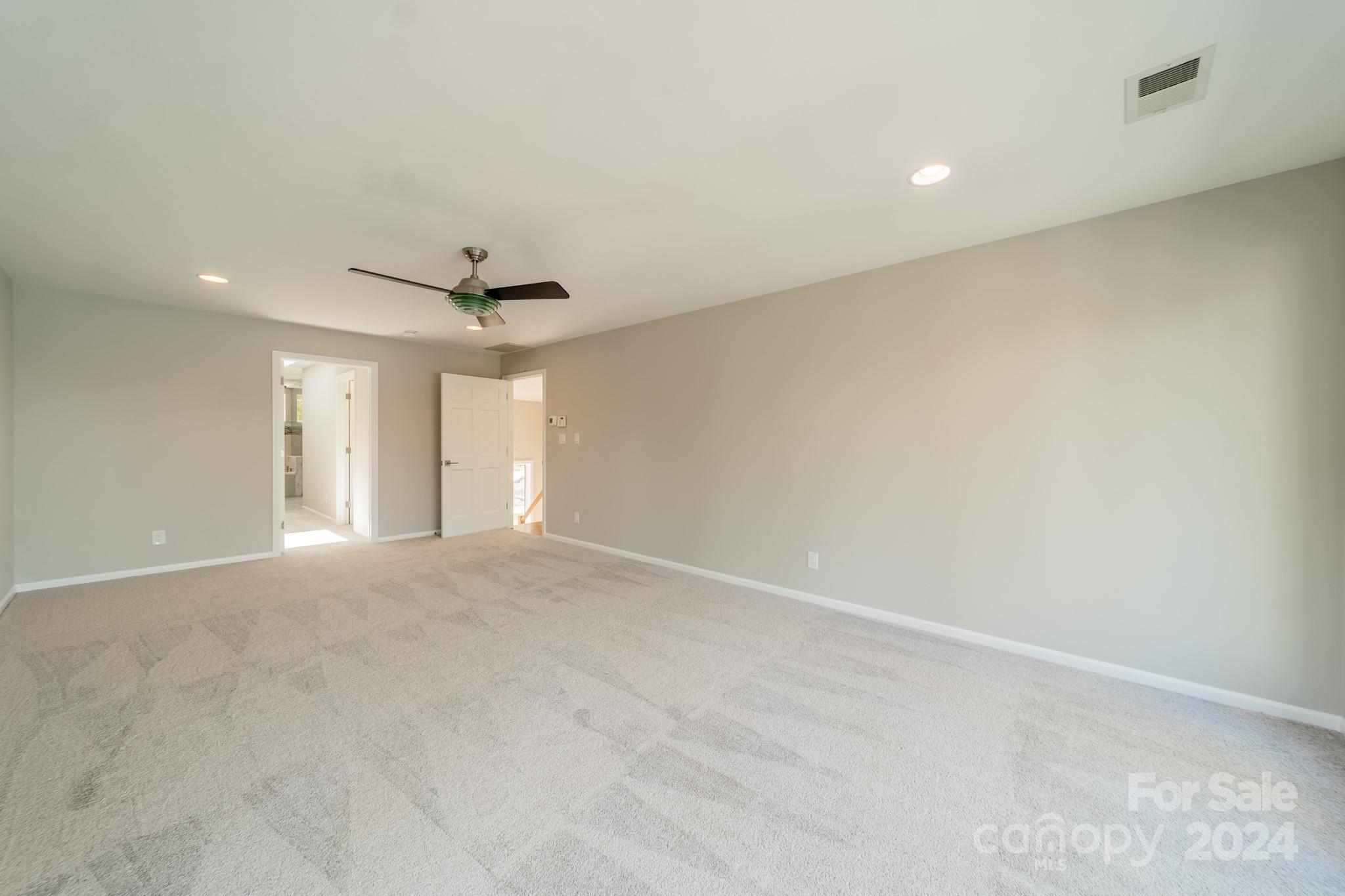 114 Stonemarker Road Mooresville, NC 28117 - Photo 26 of 38 a view of an empty room with a ceiling fan