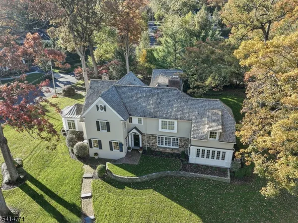 a view of house with a yard and deck
