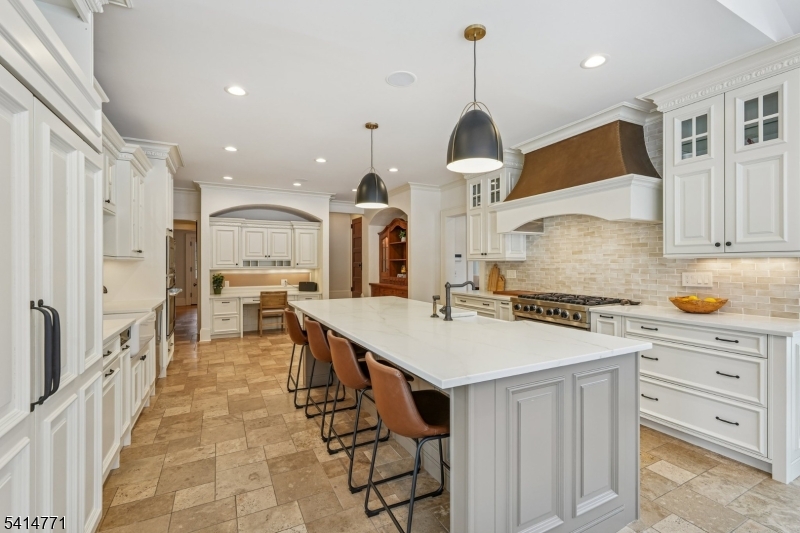 55 Oxbow Lane Summit, NJ 07901 - Photo 11 of 50 a kitchen with stainless steel appliances kitchen island granite countertop a stove a sink and a refrigerator