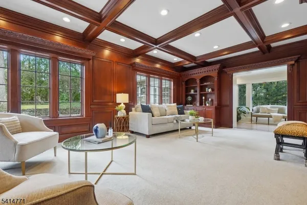 a living room with furniture and floor to ceiling windows