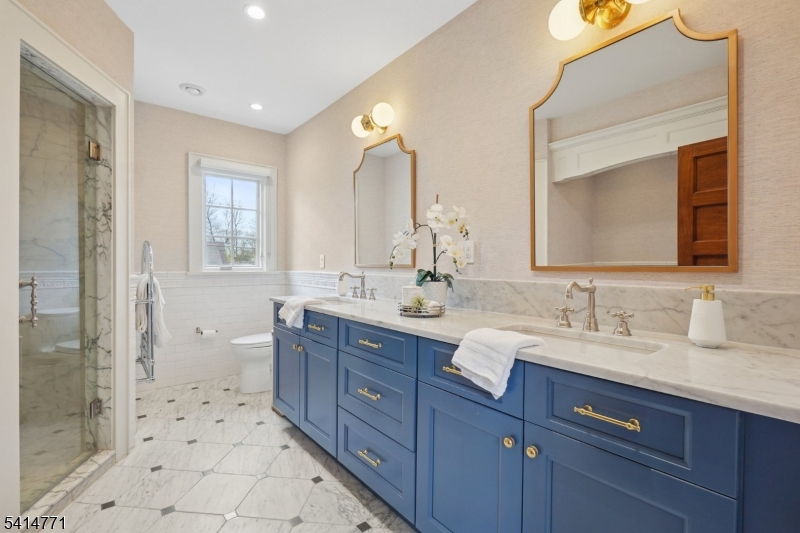 55 Oxbow Lane Summit, NJ 07901 - Photo 23 of 50 a bathroom with a double vanity sink mirror double shower and a toilet