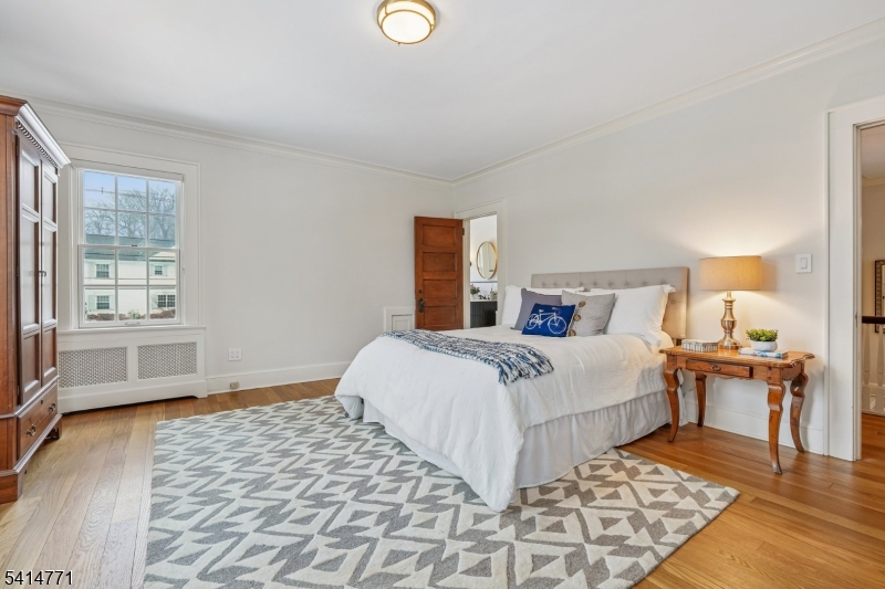 55 Oxbow Lane Summit, NJ 07901 - Photo 27 of 50 a bedroom with a bed and wooden floor