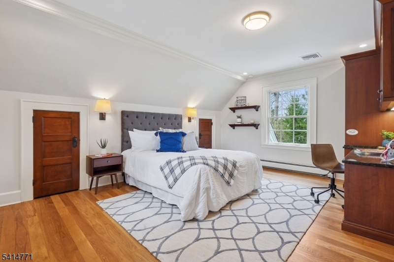 55 Oxbow Lane Summit, NJ 07901 - Photo 29 of 50 a bedroom with a bed and wooden floor