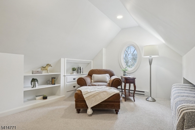 55 Oxbow Lane Summit, NJ 07901 - Photo 32 of 50 a bedroom with a bed a clock and a bookshelf with wooden floor