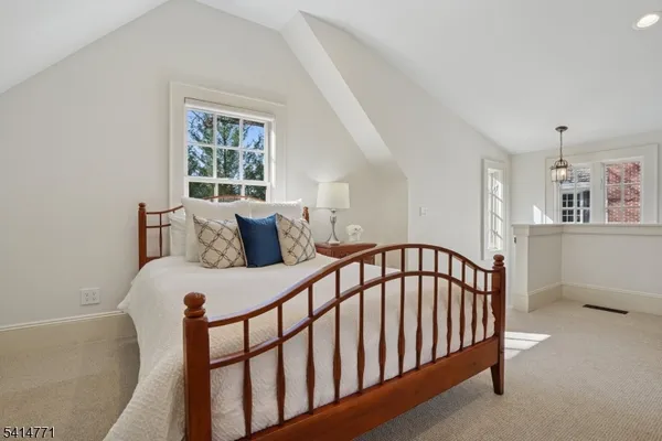 a bathroom with a toilet sink vanity and mirror
