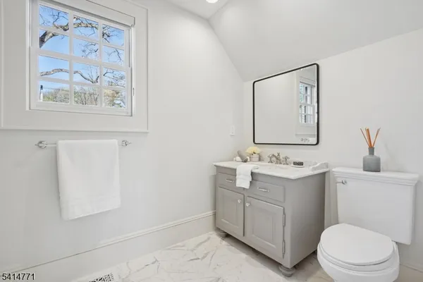 a view of a livingroom with furniture and stairs