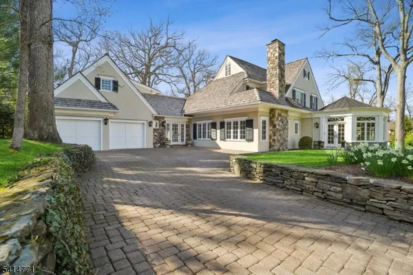 a front view of a house with yard and green space