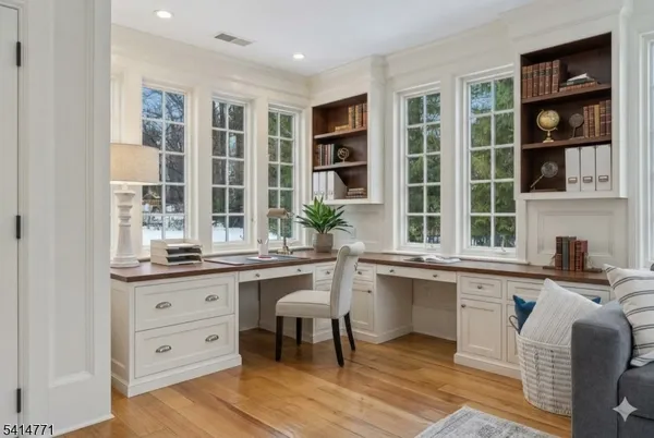 a view of a dining room with furniture wooden floor and a chandelier