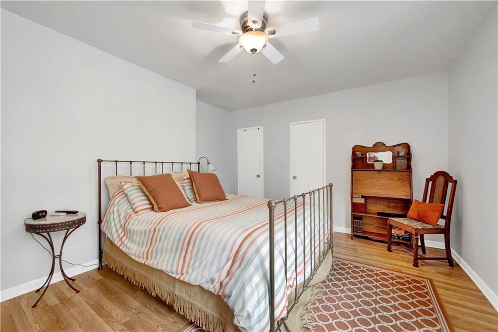 9411 Shore Road, Unit 1A Brooklyn, NY 11209 - Photo 11 of 19 a bedroom with bed and a chandelier