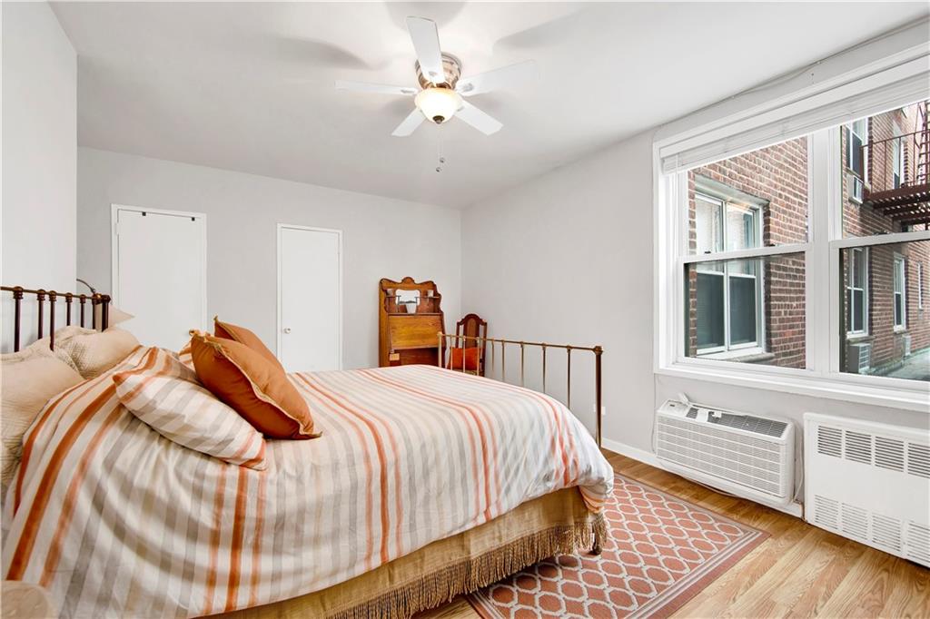 9411 Shore Road, Unit 1A Brooklyn, NY 11209 - Photo 12 of 19 a bedroom with a bed and a chandelier