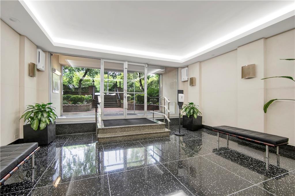 9411 Shore Road, Unit 1A Brooklyn, NY 11209 - Photo 18 of 19 a living room filled with furniture and a potted plant