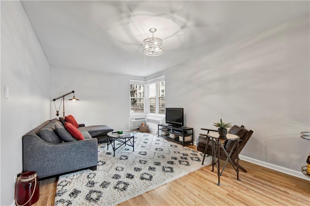 9411 Shore Road, Unit 1A Brooklyn, NY 11209 - Photo 5 of 19 a living room with furniture and a flat screen tv
