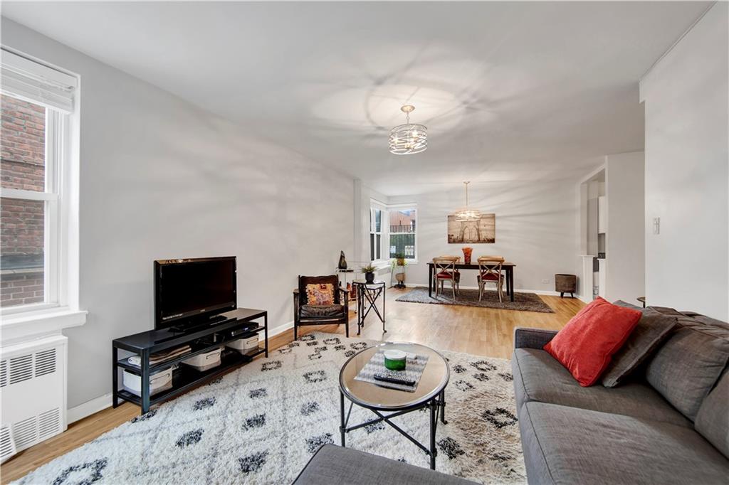 9411 Shore Road, Unit 1A Brooklyn, NY 11209 - Photo 6 of 19 a living room with furniture and a flat screen tv