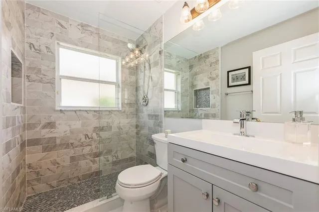 a bathroom with a sink toilet and shower