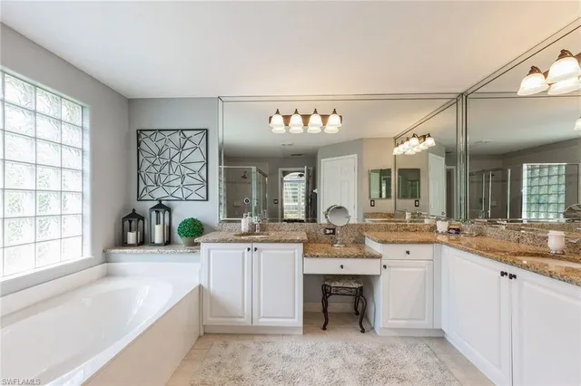 a large white kitchen with a large window