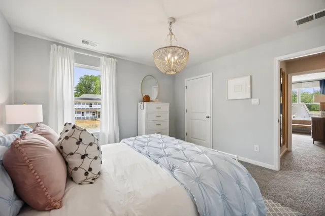 a bedroom with a large bed and a window