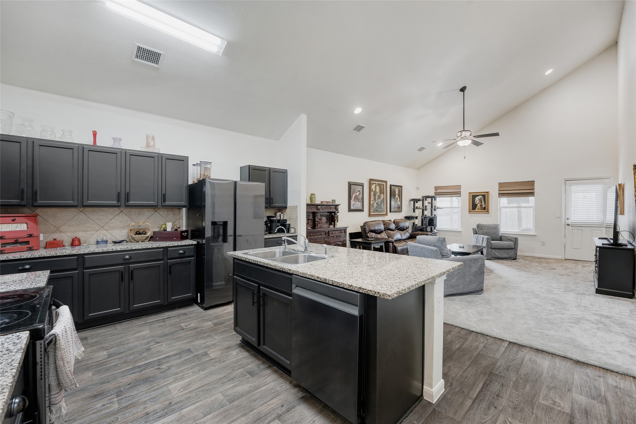 15105 Shell Bark Cove Austin, TX 78724 - Photo 6 of 30 An open-concept design connects the kitchen with granite countertops to the comfortable living area.