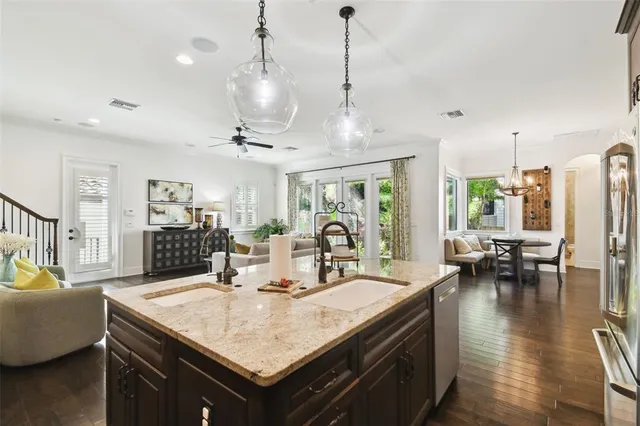 a kitchen with a table chairs and living room view