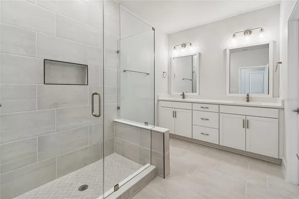 a bathroom with a sink vanity and a mirror