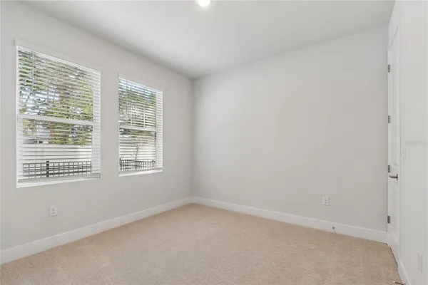 an empty room with a cabinet and a window