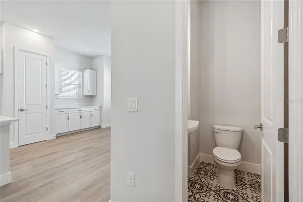 a white toilet sitting next to a bathroom sink
