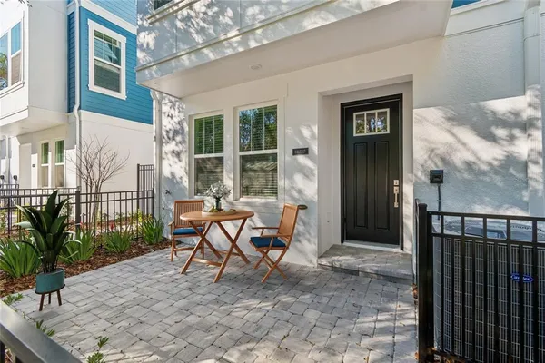 a large white kitchen with kitchen island a stove a sink a center island and wooden floor