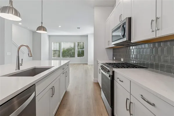a kitchen with stainless steel appliances a sink and a window