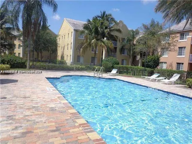 a palm tree sitting in front of a house with a yard