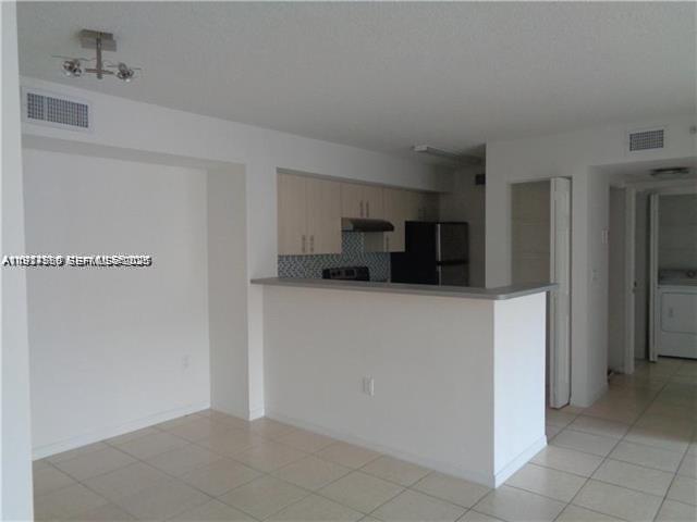 720 Southwest 111th Avenue, Unit 207 Pembroke Pines, FL 33025 - Photo 12 of 13 a view of kitchen with cabinets
