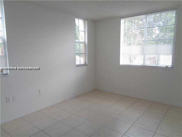720 Southwest 111th Avenue, Unit 207 Pembroke Pines, FL 33025 - Photo 6 of 13 an empty room with windows