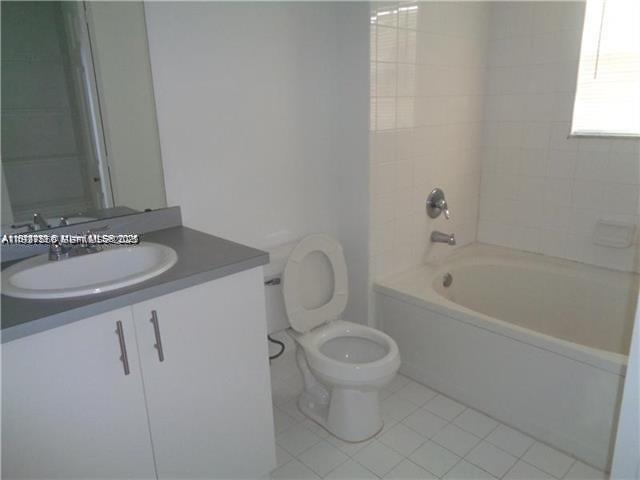 720 Southwest 111th Avenue, Unit 207 Pembroke Pines, FL 33025 - Photo 8 of 13 a bathroom with a granite countertop sink a toilet and bathtub