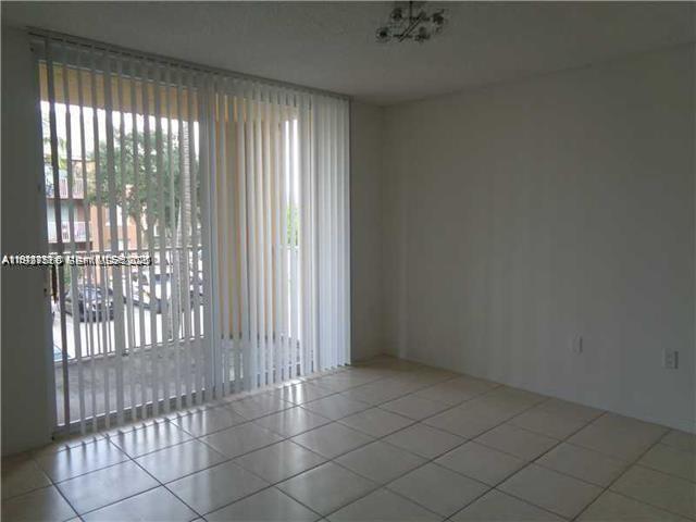 720 Southwest 111th Avenue, Unit 207 Pembroke Pines, FL 33025 - Photo 9 of 13 a view of an empty room and window