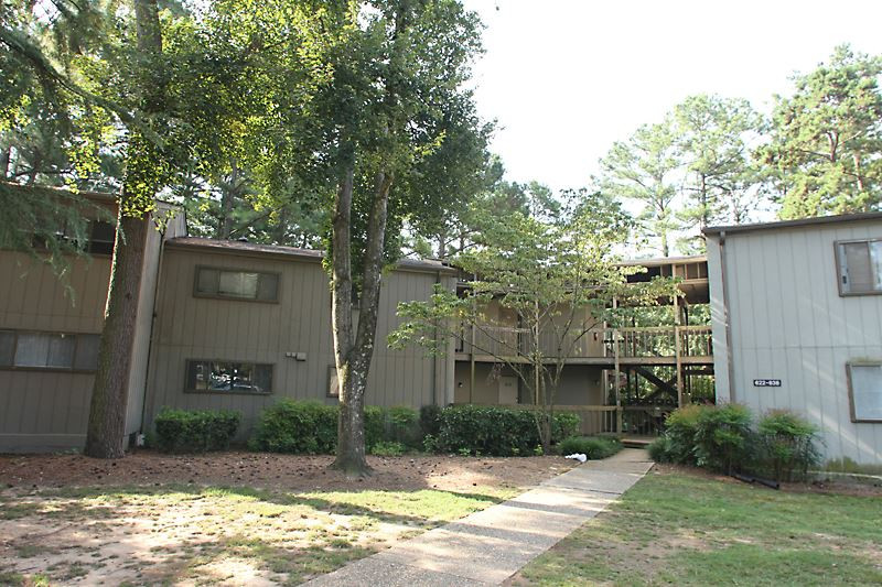 Parking lot view of Condo Building. Unit is on Basement Level. Mailboxes at Entrance. Staircase Downstairs to Entrance. Exterior Front